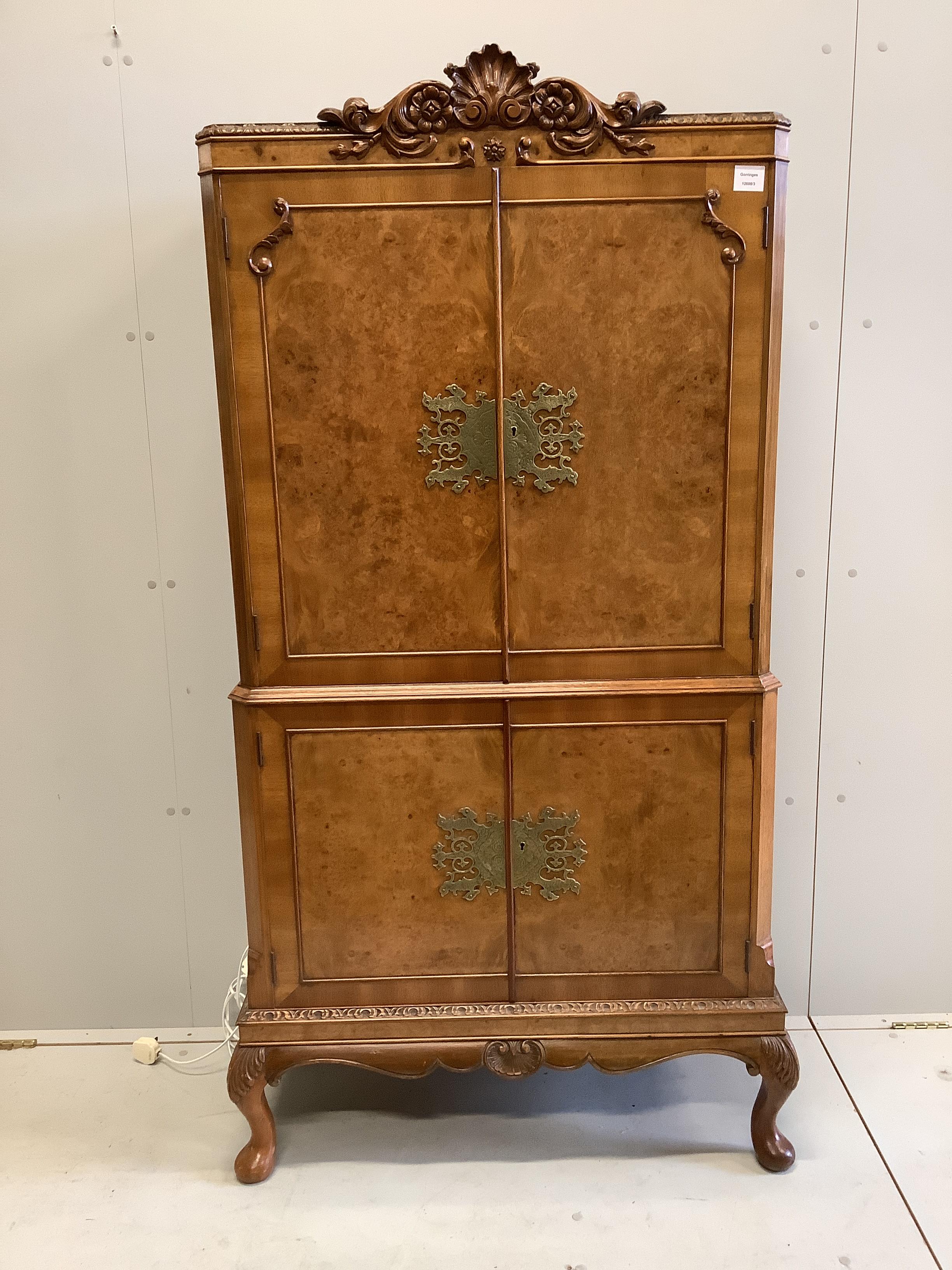 A Queen Anne Revival walnut cocktail cabinet, width 80cm, depth 40cm, height 167cm